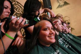 Alma Avila smiles as her head gets shaved during the St. Baldrick's head shaving fundraiser for cancer Saturday, March 1, 2014 at McMillan's Irish Pub.